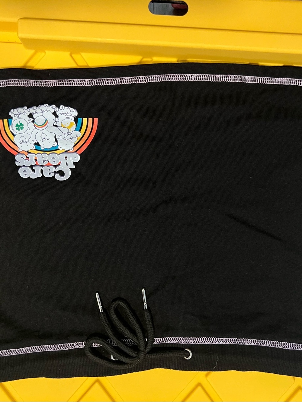 Care Bears Black Fleece Garment with Purple Overlock Stitching